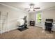 Bedroom with neutral paint, carpeted floors, a ceiling fan, and bright natural light from the large window at 8938 Glencroft Rd, Mint Hill, NC 28227