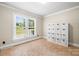 Cozy bedroom with large window and storage unit at 8938 Glencroft Rd, Mint Hill, NC 28227