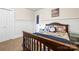 Bedroom featuring neutral paint, carpeted floors, and a comfortable bed with colorful plaid bedding at 8938 Glencroft Rd, Mint Hill, NC 28227