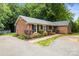 Charming brick home featuring manicured landscaping, a circular driveway, and a welcoming entrance at 8938 Glencroft Rd, Mint Hill, NC 28227