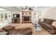 Cozy living room featuring a brick fireplace, neutral color palette, and comfortable seating at 8938 Glencroft Rd, Mint Hill, NC 28227