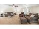 Cozy living room with comfortable seating, ceiling fan, and bright natural light at 8938 Glencroft Rd, Mint Hill, NC 28227