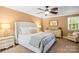Serene main bedroom with large bed, bedside tables, and ample natural light at 8938 Glencroft Rd, Mint Hill, NC 28227