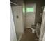 A small bathroom with neutral walls contains a walk in shower, toilet, and sink at 9401 Gold Hill Rd, Mount Pleasant, NC 28124