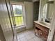 Bathroom with vintage vanity, tile floors, open storage closet, and a large picture window at 9401 Gold Hill Rd, Mount Pleasant, NC 28124