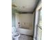 Bathroom featuring a white tub-shower combination with tiled walls and a standard toilet at 9401 Gold Hill Rd, Mount Pleasant, NC 28124