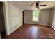 Bedroom featuring wood floors, neutral paint, a ceiling fan, a window and ample natural light at 9401 Gold Hill Rd, Mount Pleasant, NC 28124