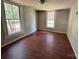A bedroom space offers natural lighting, wood floors and neutral colored walls at 9401 Gold Hill Rd, Mount Pleasant, NC 28124