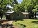 Quaint house with mature trees is situated on a beautiful lot with plenty of shade at 9401 Gold Hill Rd, Mount Pleasant, NC 28124