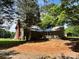 Rear exterior view shows the house with mature trees surrounding it, creating a private backyard at 9401 Gold Hill Rd, Mount Pleasant, NC 28124