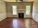 A spacious living room with wood flooring, neutral paint, windows and a brick fireplace at 9401 Gold Hill Rd, Mount Pleasant, NC 28124