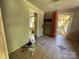 View of a living room with beige walls and a tan tiled floor with an opening to the next room at 9401 Gold Hill Rd, Mount Pleasant, NC 28124