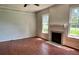 Living room with neutral paint, wood floors and a fireplace features two windows for natural lighting at 9401 Gold Hill Rd, Mount Pleasant, NC 28124