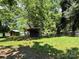 An old storage shed on the back of the property could be repurposed for various uses at 9401 Gold Hill Rd, Mount Pleasant, NC 28124