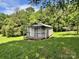 View of exterior outbuilding showing its aged wood construction and a covered porch at 9401 Gold Hill Rd, Mount Pleasant, NC 28124