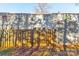 View of fenced backyard and exterior of townhomes with shade from mature trees at 9464 Lexington Cir # B, Charlotte, NC 28213