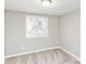 A bedroom features a double-hung window and neutral-toned carpet at 9464 Lexington Cir # B, Charlotte, NC 28213