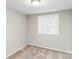 A bedroom features a double-hung window and neutral-toned carpet at 9464 Lexington Cir # B, Charlotte, NC 28213