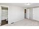 A bright bedroom featuring neutral walls and two access doors at 9464 Lexington Cir # B, Charlotte, NC 28213