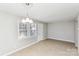 Bright dining area with tile flooring, a modern chandelier, and natural light, perfect for Gathering meals at 9464 Lexington Cir # B, Charlotte, NC 28213