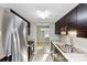 Modern kitchen featuring stainless steel appliances, granite countertops, and dark cabinets, offering a sleek cooking space at 9464 Lexington Cir # B, Charlotte, NC 28213