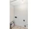 Utility room with tile flooring and essential hookups, ready for your washer and dryer installation at 9464 Lexington Cir # B, Charlotte, NC 28213