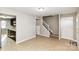 A bright living space with tile floors leads to the staircase and kitchen, offering an open and airy feel at 9464 Lexington Cir # B, Charlotte, NC 28213