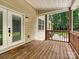 Cozy covered back porch leads to an outdoor entertainment area, perfect for relaxation and gatherings at 9507 Reid Hall Ln, Matthews, NC 28105