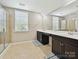 Bright bathroom featuring a double sink vanity, and a glass-enclosed shower, for a relaxing experience at 9507 Reid Hall Ln, Matthews, NC 28105