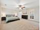 Large bedroom featuring neutral tones, a ceiling fan, and ample space for furniture at 9507 Reid Hall Ln, Matthews, NC 28105