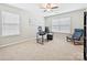 Versatile bedroom space, perfect for a home office or guest room, featuring carpeted floors and abundant natural light at 9507 Reid Hall Ln, Matthews, NC 28105