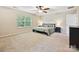 Spacious bedroom with large window, ceiling fan, and neutral decor providing a relaxing atmosphere at 9507 Reid Hall Ln, Matthews, NC 28105