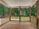 Inviting covered deck overlooking the backyard with views of the surrounding trees and greenery at 9507 Reid Hall Ln, Matthews, NC 28105