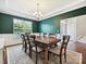 Formal dining room with hardwood floors, a large window, a modern chandelier, and seating for eight at 9507 Reid Hall Ln, Matthews, NC 28105