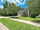 Charming two-story home featuring a manicured lawn and a two-car garage, complemented by lush trees at 9507 Reid Hall Ln, Matthews, NC 28105