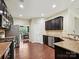 A well-equipped kitchen with dark cabinets, stainless steel appliances, and granite countertops at 9507 Reid Hall Ln, Matthews, NC 28105