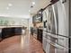 Modern kitchen features stainless steel appliances and dark wood cabinets against hardwood floors at 9507 Reid Hall Ln, Matthews, NC 28105