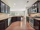 Spacious kitchen with stainless appliances, granite countertops, and dark cabinets perfect for cooking at 9507 Reid Hall Ln, Matthews, NC 28105