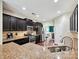 Modern kitchen featuring granite countertops, stainless steel appliances, and dark wood cabinets at 9507 Reid Hall Ln, Matthews, NC 28105