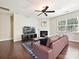 Cozy living room with a fireplace, a large window, and comfortable furnishings at 9507 Reid Hall Ln, Matthews, NC 28105