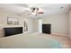 Neutral toned main bedroom featuring a ceiling fan, ample space, with french doors leading to a walk in closet at 9507 Reid Hall Ln, Matthews, NC 28105