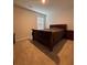 Bedroom with carpet, a window with blinds, a dark wood bed, and matching side table at 9639 Margrave Dr, Gastonia, NC 28056
