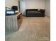 Bedroom featuring beige carpet, a printer on a wood desk, and a pull-out sofa at 9639 Margrave Dr, Gastonia, NC 28056