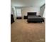 Bedroom with carpet and a dark upholstered headboard and matching side tables at 9639 Margrave Dr, Gastonia, NC 28056