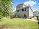 Backyard features a lawn, patio, lounge chairs, and a black metal fence at 1006 Wellington Ave, Indian Land, SC 29707
