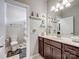 Bright bathroom featuring a single sink vanity with dark wood cabinets and an adjacent toilet with a shower at 1006 Wellington Ave, Indian Land, SC 29707