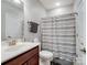 Bathroom with a single sink vanity, toilet, and a shower with a striped curtain at 1006 Wellington Ave, Indian Land, SC 29707