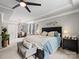 Luxurious main bedroom with tray ceilings, fan, sitting area, and ample space at 1006 Wellington Ave, Indian Land, SC 29707