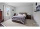 Cozy bedroom featuring a large window, comfortable bed with decorative pillows, and bedside tables at 1006 Wellington Ave, Indian Land, SC 29707