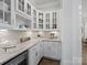 Convenient butler's pantry with white cabinetry, granite countertops, and a beverage refrigerator at 1006 Wellington Ave, Indian Land, SC 29707